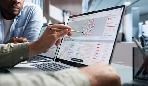 Fraud Analyst Studies Suspicious Transactions On AI Dashboard For Prevention. Stock Photos