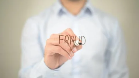 Fraud,  Man writing on transparent screen 库存照片