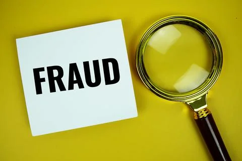 Fraud text message written on paper note with magnifying glass top view on .. Stock Photos