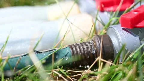 Frayed garden hose with burst section spraying water from the point of Stock Footage 202275114