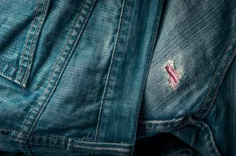 Frayed Hole on Back Side of Blue Jeans with Double Stitched Seams Stock Photos