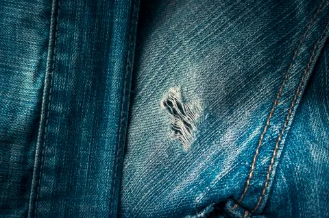 Frayed Hole on Back Side of Old Blue Jeans with Double Stitched Seams. Stock Photos