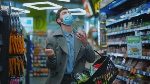 Freak comical young man dancing in middle of grocery store enjoying favorite Stock Footage 143738938