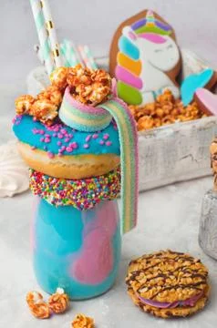 Freak shake topping with donut, popcorn over grey background Stock Photos