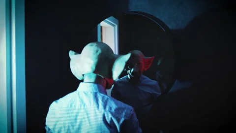 Freak sprayed with perfume in font of the mirror horror demon mask Stock Footage 210186840