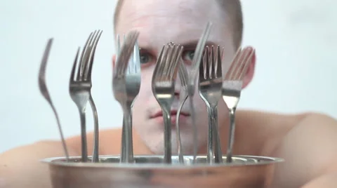 Freaky guy looking through the forks Stock Footage 48872801