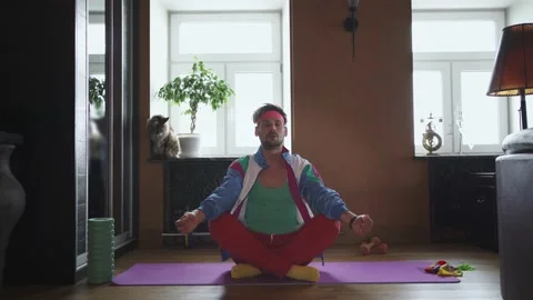 The freaky guy meditates alone at home Stock Footage 149075954