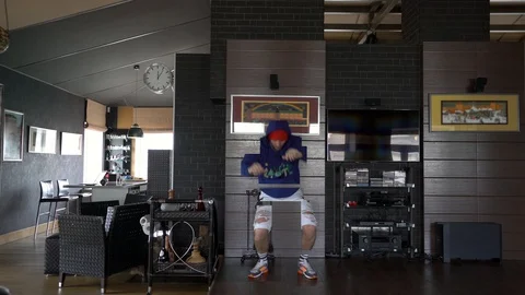 A freaky guy in self-isolation at home is dancing hip-hop. Stock Footage 128699797
