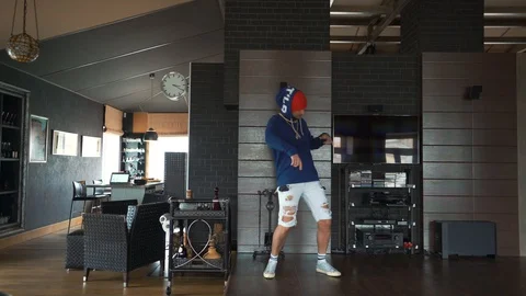 A freaky guy in self-isolation at home is dancing hip-hop Stock Footage 128700019