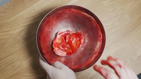 Freaky shot of man hand grab some strange Scary red bloody dough and knead it. Vídeo Stock 122821543
