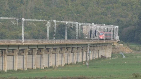 FrecciaRossa 1000 hig speed train passes over the elevated Stock Footage 100722923