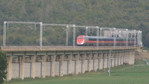 FrecciaRossa hig speed train passes over the elevated Stock Footage 100562771