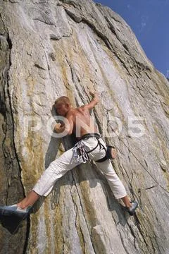 Free climber scaling cliff face Stock Photos