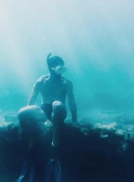 Free diver sitting on reef Stock Photos