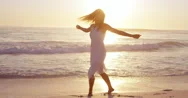 Free Happy Woman Spinning Arms Outstretched Enjoying Nature Dancing On Beach  Stock Footage