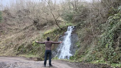 Free man waterfall Stock Footage 264015699