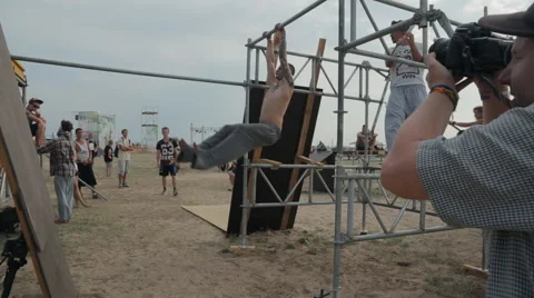 Free Runner Performing Tricks on The Crossbars on the coast Stock Footage 60687794