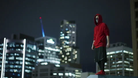 Free Runner Standing on top of the building at night Stock Footage 264202316