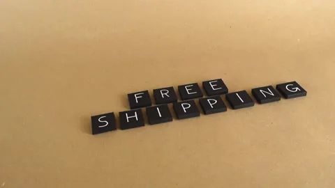 Free shipping text composed with black tiles on a paper background Stock Footage 341861508