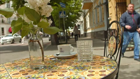 Free table with flowers a cup of coffee. fresco table and chair Stock Footage 198687629