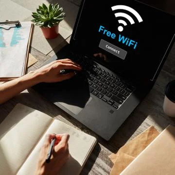 Free wifi connection on device screen. Internet and wireless technology concept. Stock Photos