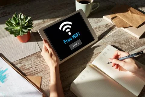 Free wifi connection on device screen. Internet and wireless technology concept. Stock Photos