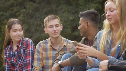 Free young people communicating with each other friendly outdoors Stockbeeldmateriaal 74634993