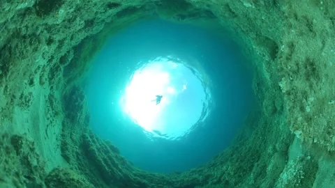 A freediver descends to the seabed in a beam of light 1 Stock Footage 199977801