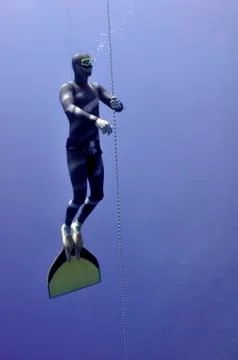 Freediver slowly surface Stock Photos