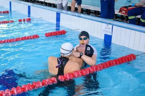 Freediving competition in a pool displaying teamwork and dedication Stock Photos