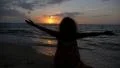 Freedom and Happiness Concept. Young Woman Spreading Arms towards Sunset. Slow HD Footage