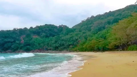 Freedom Beach panoramic turquoise waves rocks rain clouds Karon Phuket Thai.. Stock-Footage 346136714