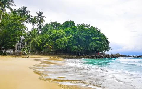 Freedom Beach sand waves rocks rain clouds tropical palms Karon Phuket Thai.. Stock Photos