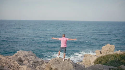 Freedom Concept Man Facing the Ocean with Open Arms 스톡 동영상 330665590
