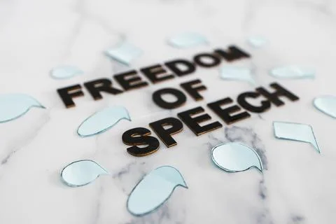 Freedom of speech text surrounded by group of different comic bubbles represe Stock Photos