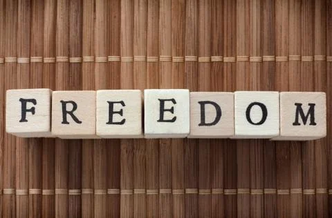Freedom word written on wooden blocks Stock Photos
