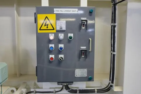 Freefall lifeboat davit control panel with high voltage sign on bulk carrier Stock Photos