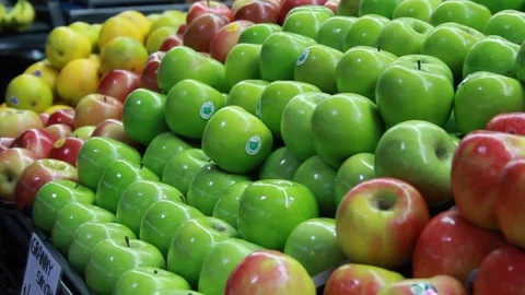 A freehand shot of a stack of apples at a local market Stock Footage 87857089
