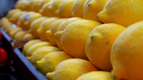 A freehand shot of a stack of lemons at a market stall Stock Footage 87857090