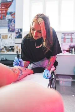 Freehand technique, drawing a pattern with a blue marker, vertical shot, tattoo Stock Photos