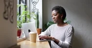Freelance African American Businesswoman Working In A Cafe Stock Footage