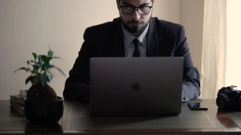 A freelance broker working from home on his laptop Stock Footage 129304580