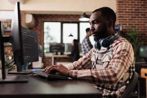 Freelance coder typing javascript code on computer Stock Photos