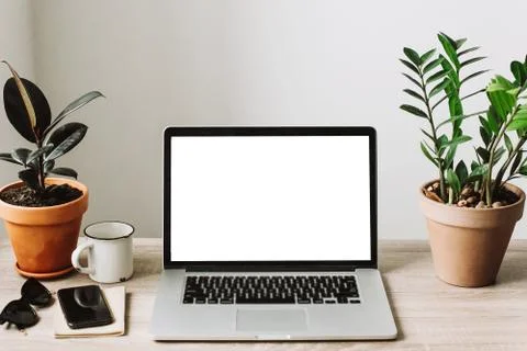 Freelance concept. Laptop with empty screen on wooden desktop with phone, not Stock Photos