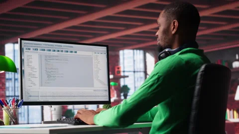 Freelance developer writing code in a modern programming language Stock Footage 307796389