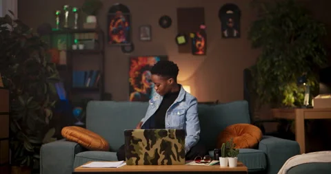 Freelance graphic designer or web developer African woman diligently works in Stock Footage 245147017