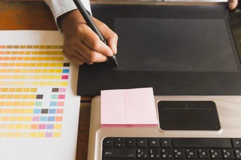 Freelance graphic designer using digital tablet, computer, man working with.. Stock Photos