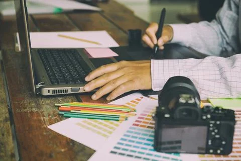 Freelance graphic designer using digital tablet, computer, man working with.. Stock Photos