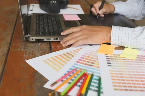 Freelance graphic designer using digital tablet, computer, man working with.. Foto stock