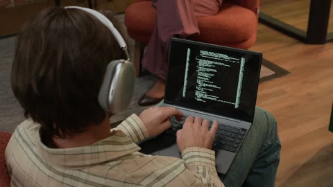 Freelance IT Specialist Coding on Laptop in Modern Coworking Space Stock Footage 319992988